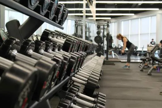 A bright fitness club floor with cardio and strength equipment