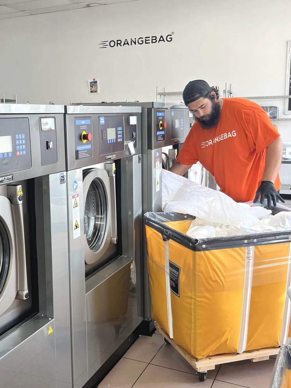 An OrangeBag team member loading linens at the Los Angeles plant
