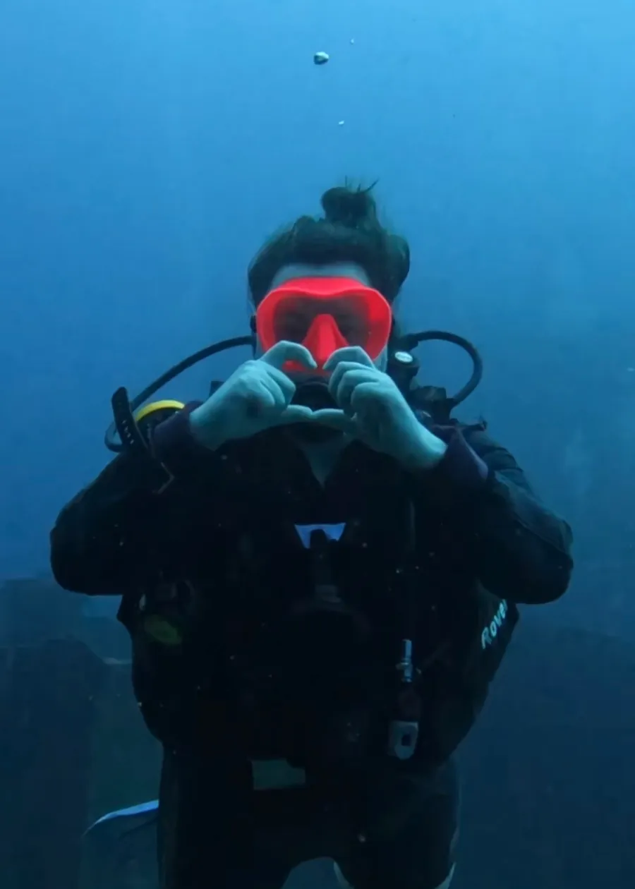 Mariya scuba diving in a red mask