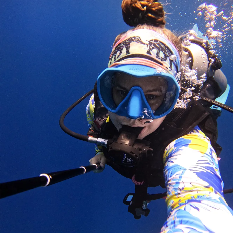 Sam scuba diving in a blue mask