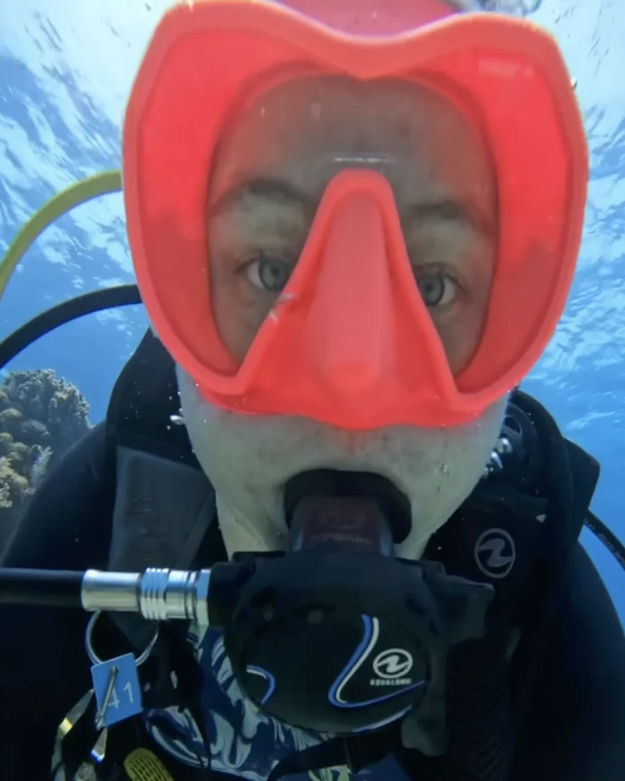 Mariya in a red dive mask looking into the camera